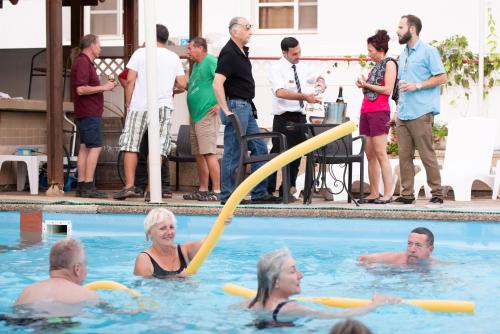 a group of people in a swimming pool at Astoria Galilee Hotel in Tiberias