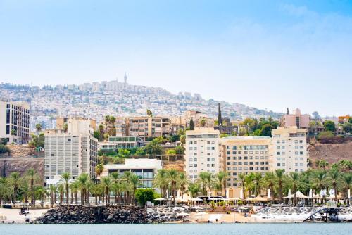 a view of a city with palm trees and buildings at Astoria Galilee Hotel in Tiberias