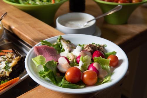 a salad in a white bowl on a table at Astoria Galilee Hotel in Tiberias