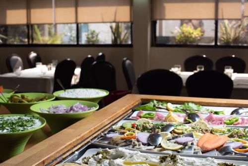 a table topped with lots of different types of food at Astoria Galilee Hotel in Tiberias