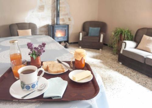 a tray of food on a table in a living room at Casa Rural Marila in Puigmoreno
