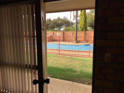 a view of a pool through a sliding glass door at Kadina Gateway Motor Inn in Kadina