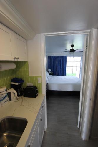 a kitchen with a sink and a bedroom with a bed at Ocean Reef Yacht Club & Resort in Freeport