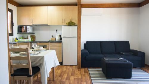 a living room with a table and a blue couch at Quintinha da Charneca in Alfeizerão