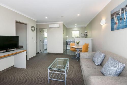 a living room with a couch and a table at Fairley Motor Lodge in Napier