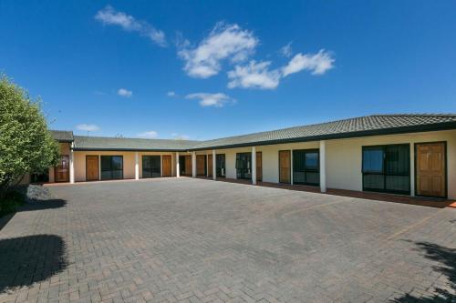 an empty parking lot in front of a building at Fairley Motor Lodge in Napier