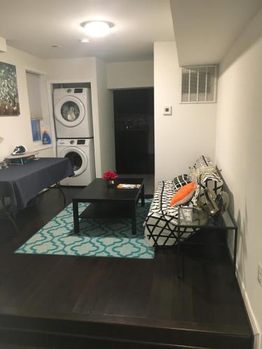a living room with a washing machine and a couch at Cozy Rowhouse Next JHH in Baltimore