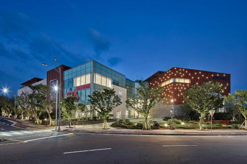 a building with a street in front of it at Somerset Jeju Shinhwa World in Seogwipo