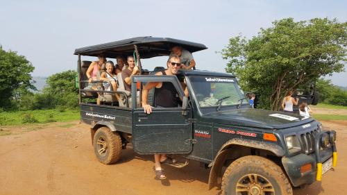 a group of people in a jeep on a dirt road at Yonan River Face Safari Resort in Udawalawe