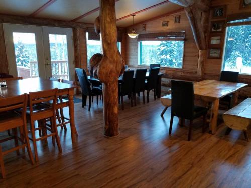 a dining room with wooden tables and chairs at Northern Sky Lodge in Fairbanks