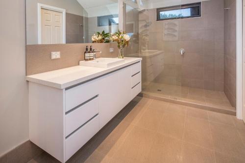 a bathroom with a white sink and a shower at Top of the Hill in Yallingup