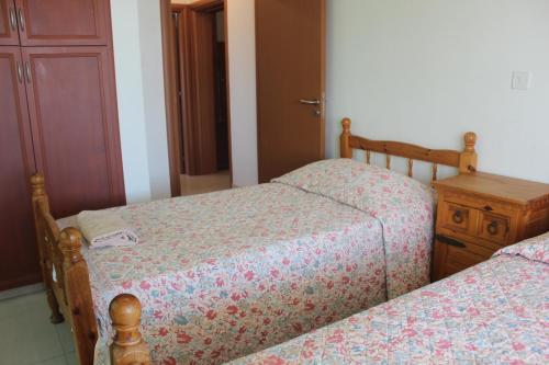 two beds sitting next to each other in a bedroom at Galatia's Court in Paphos City