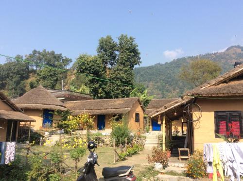 a motorcycle parked in front of a house with a mountain at My beautiful cottage in pokhara in Pokhara