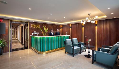 two men standing at a bar in a hotel lobby at Stellar of the Seas Cruise in Ha Long