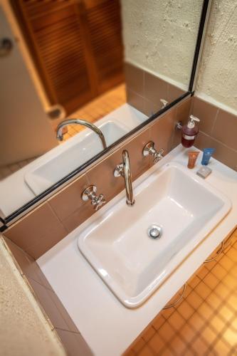 a bathroom with a sink and a mirror at Snowgums 07 in Dinner Plain
