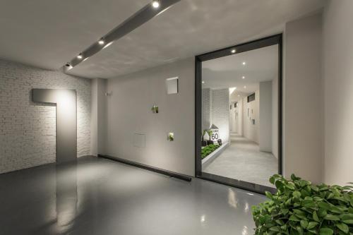 a large mirror in a room with a hallway at H suite Go in Changhua City