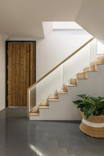 a staircase in a house with a potted plant at H suite Go in Changhua City