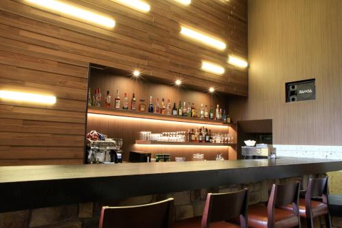 a bar in a restaurant with chairs around it at Karuizawakurabu Hotel 1130 Hewitt Resort in Tsumagoi