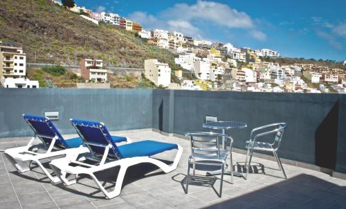 a patio with chairs and a table on a roof at Hotel La Colombina in San Sebastián de la Gomera