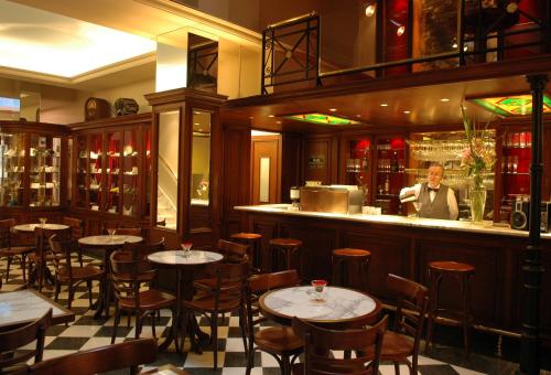 a man standing behind a bar in a restaurant at Tanguero Hotel Boutique Antique in Buenos Aires