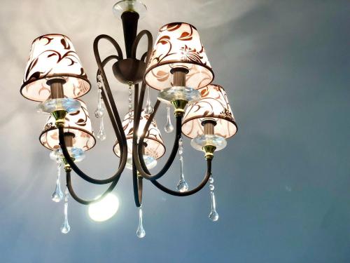 a chandelier hanging from the ceiling in a room at Puli Story House in Puli