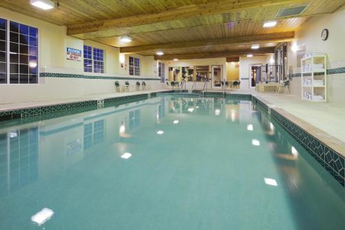 a swimming pool with blue water in a building at Country Inn & Suites by Radisson Kenosha - Pleasant Prairie in Kenosha