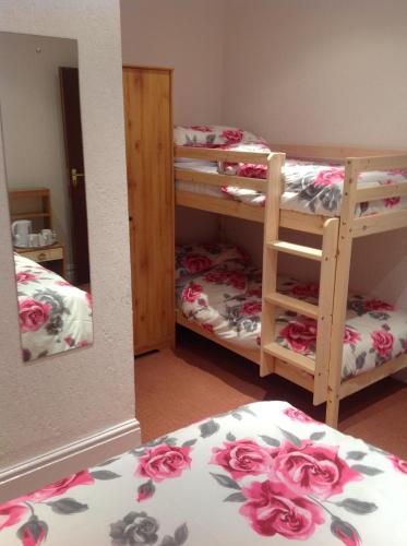 a room with two bunk beds and a mirror at The Danescourt in Blackpool