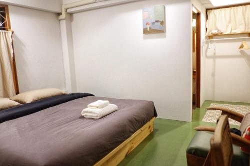 a room with a bed with towels on it at Paiyannoi Guesthome in Chiang Mai