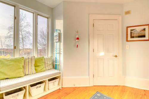 a living room with a bench and a window at Sea At Last in Phippsburg