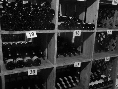 a bunch of wine bottles on shelves in a store at Hostellerie d'Héloïse Logis in Cluny