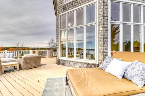 a room with a bed on a porch with a patio at Sea At Last in Phippsburg