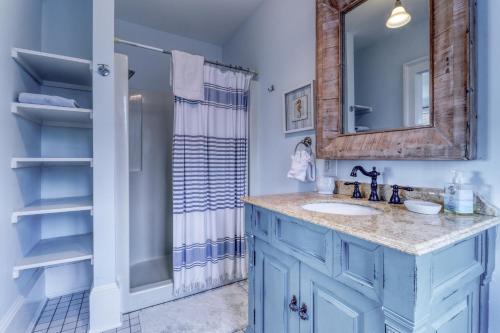 a blue bathroom with a sink and a shower at Sea At Last in Phippsburg