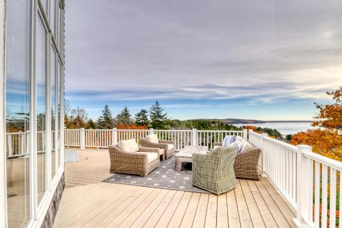 a balcony with chairs and a view of the water at Sea At Last in Phippsburg