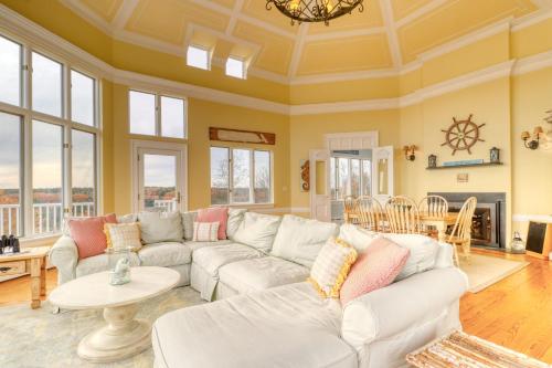 a living room with a couch and a table at Sea At Last in Phippsburg