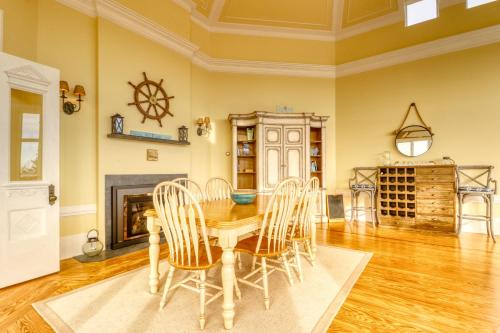 a dining room with a table and chairs and a fireplace at Sea At Last in Phippsburg