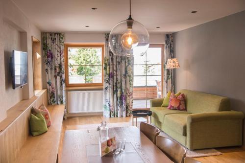 a living room with a couch and a table at Hotel Stäfeli in Lech am Arlberg