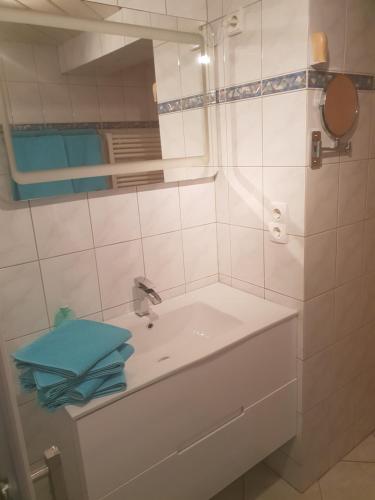 a white bathroom with a sink and a mirror at Eifelflair in Retterath