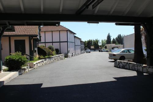 a car parked in a parking lot next to a building at Best Whittier Inn in Whittier