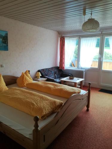 a bedroom with two beds and a window at Hotel Kaltenbach in Triberg