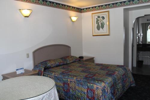 a hotel room with a bed and a table at Best Whittier Inn in Whittier