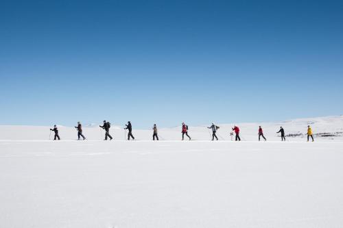 a group of people walking in the snow at Hotell Bruksvallsliden in Bruksvallarna