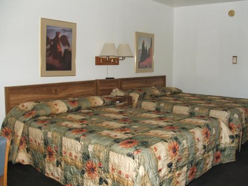 a hotel room with two beds in a room at Arizona Inn in Kingman