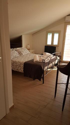 a bedroom with a bed and a chair at La Porta dell'Alcantara in Gaggi