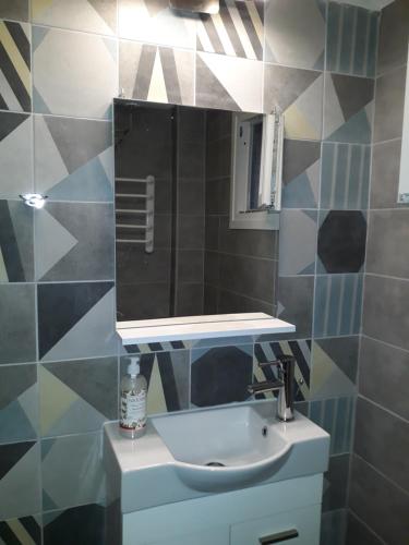 uma casa de banho com um lavatório e um espelho em Aristotelous 1 min supercentral Mini studio- renewed with brand new professional orthopedic mattresses em Tessalônica