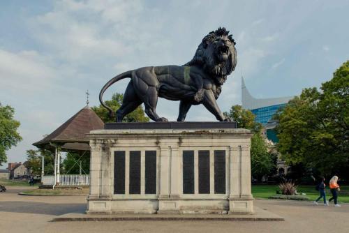 a statue of a lion on top of a building at PREMIER SUITES Reading in Reading