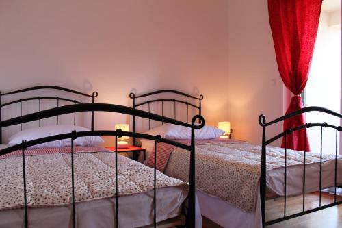two twin beds in a room with a window at Villa Marija in Marina