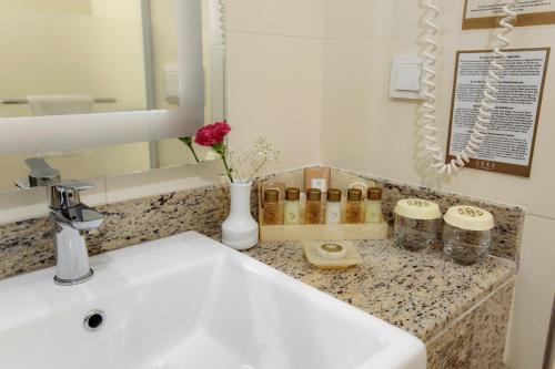 a bathroom counter with a sink and a mirror at Akka Alinda Hotel - Premium Ultra All Inclusive in Kemer