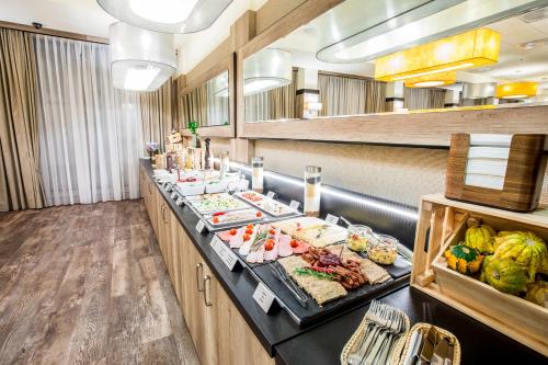 a buffet line with many different types of food at Park Hotel Diament Wroclaw in Wrocław