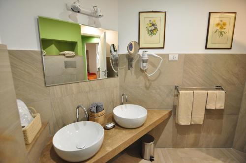 a bathroom with two sinks and a mirror at Delco Naples in Naples