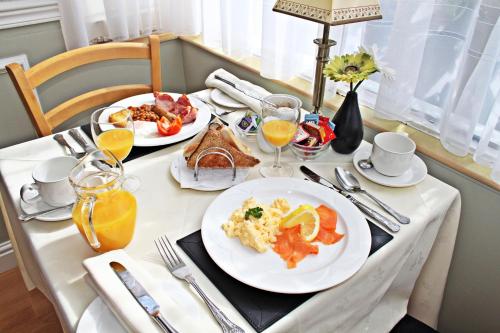 a table with two plates of breakfast food on it at The Baytree in Torquay